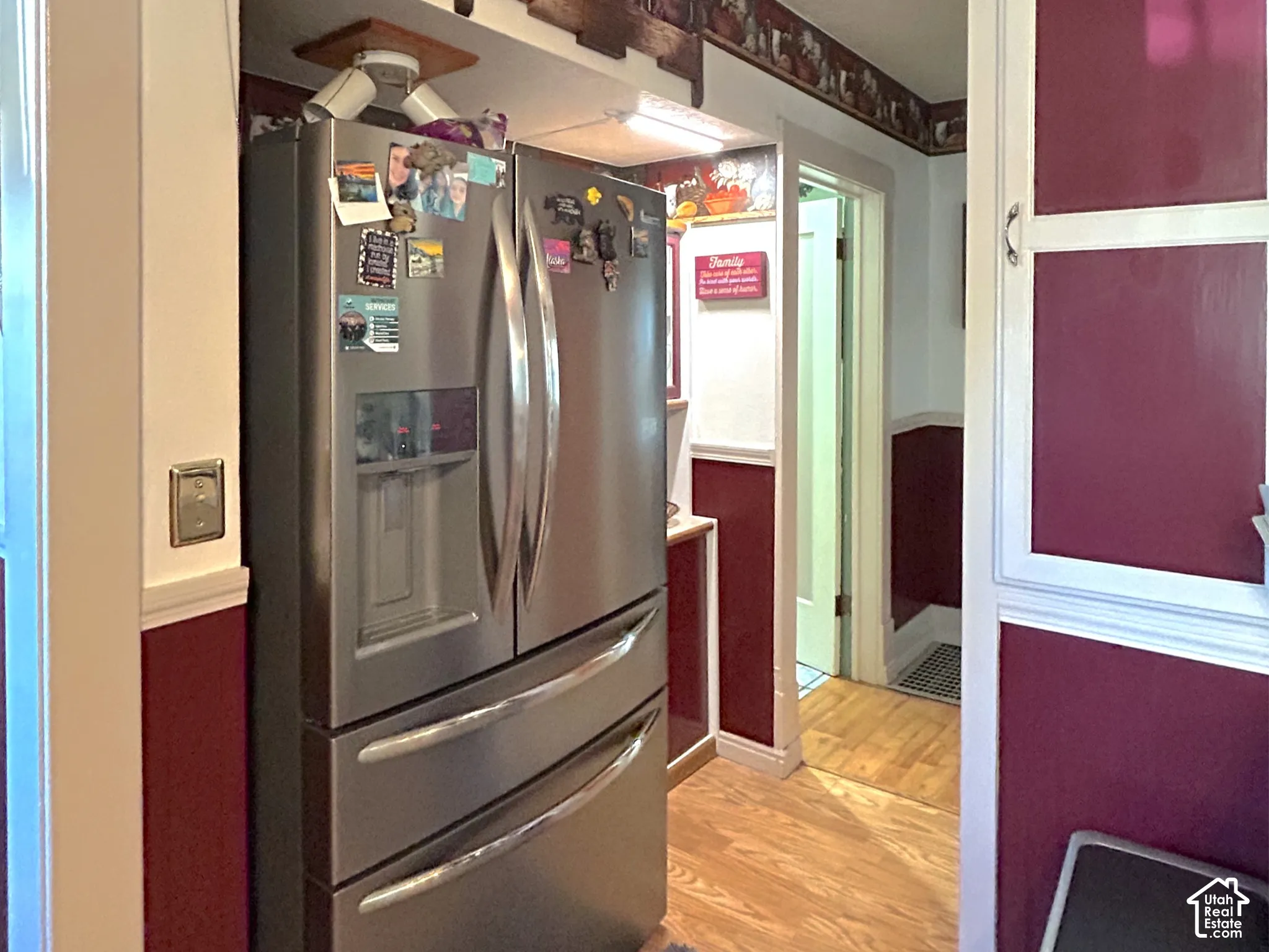 Wood-finish flooring with white trim and a contrasting wall color