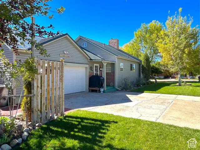 Exterior featuring a metal roof, attached garage, and vinyl siding