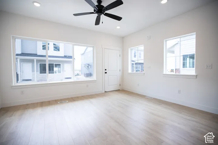 Family room with 9' ceiling and ceiling fan.