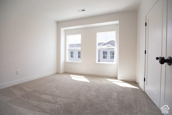 Primary bedroom with 9' ceiling and ceiling fan.