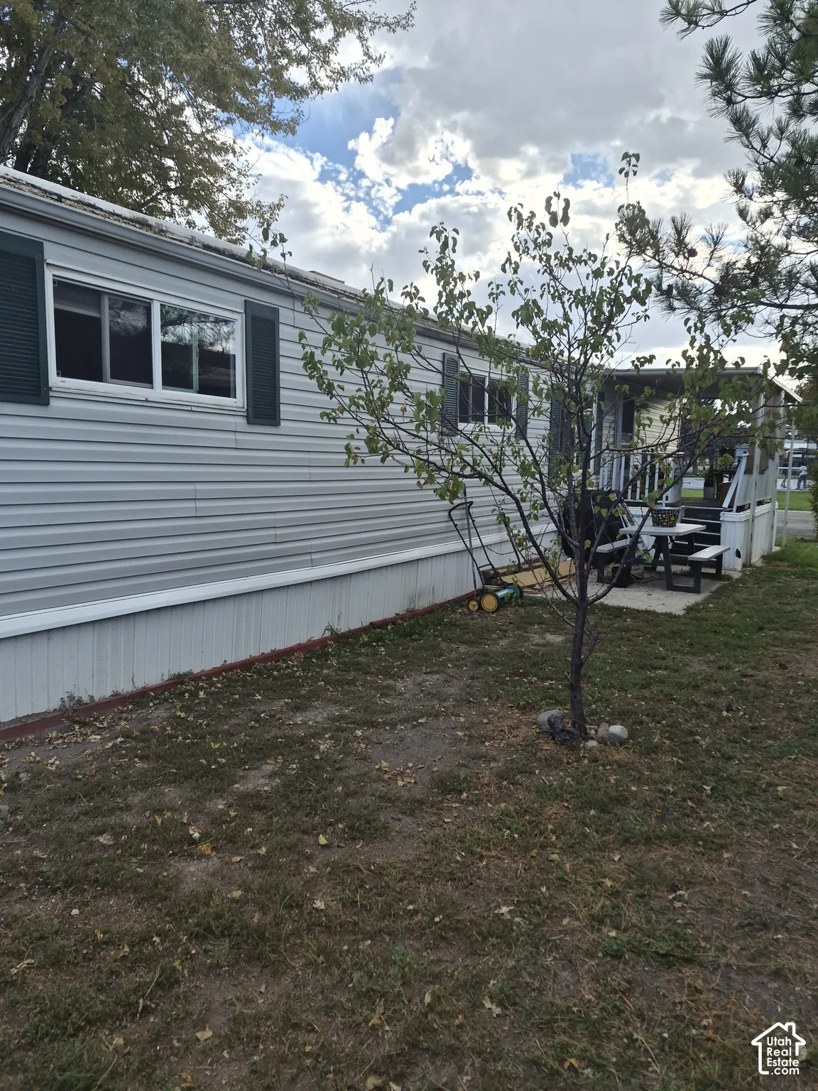 Siding exterior with decorative shutters and covered porch