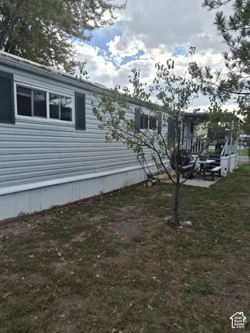 Siding exterior with decorative shutters and covered porch
