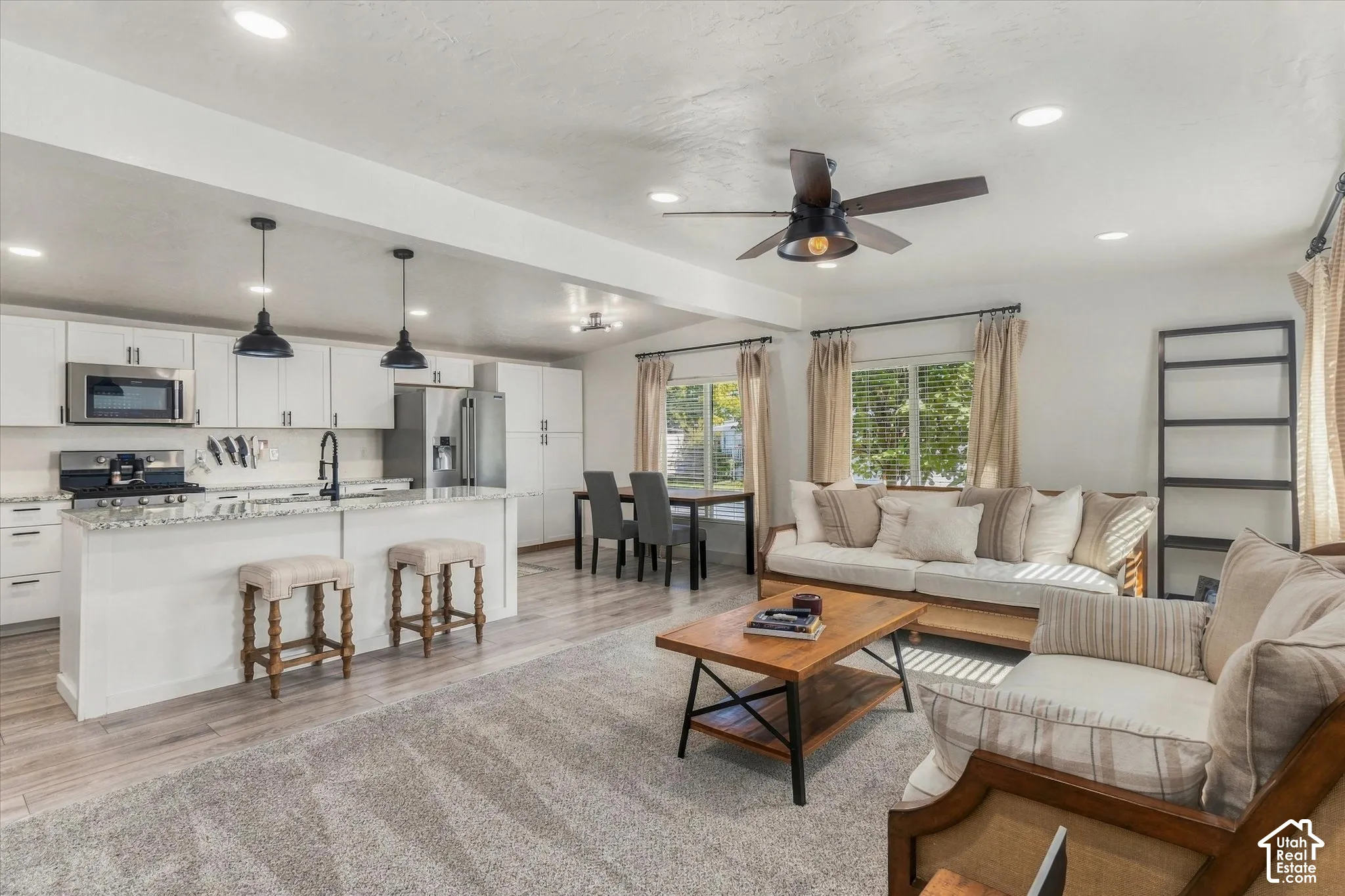 Open-concept living space with recessed lighting and wood-finish flooring