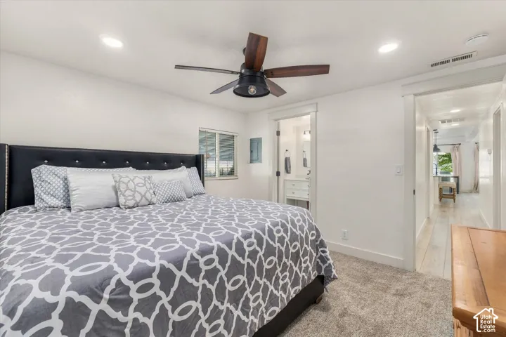Recessed lighting, ceiling fan with wood-finish blades, white trim, carpet flooring, and an adjoining bathroom