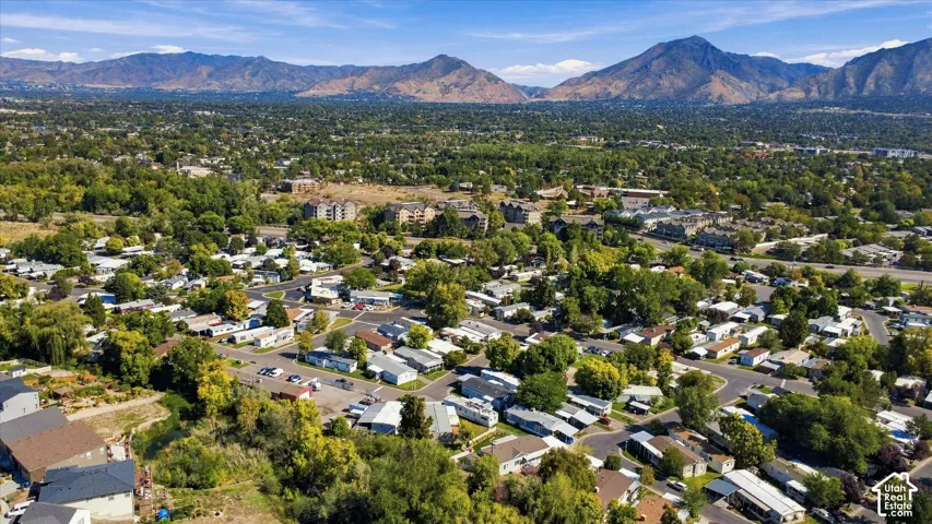 Expansive residential area with abundant mature trees and mountainous terrain