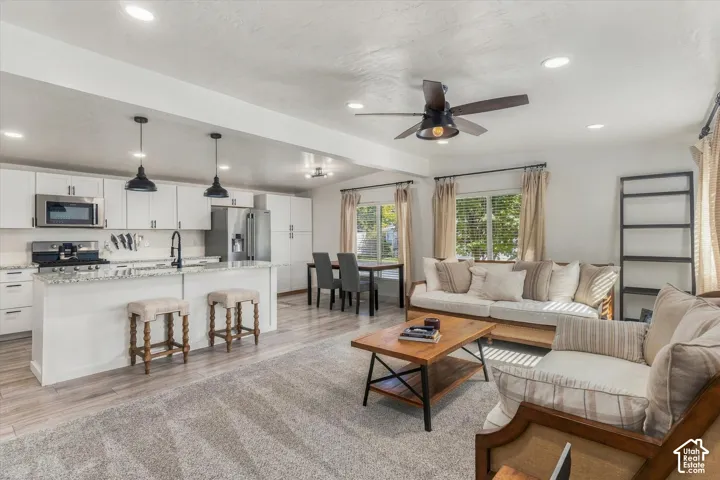 Open-concept living space with recessed lighting and wood-finish flooring