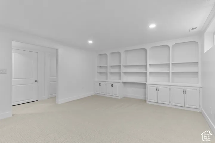 Built-in shelving and cabinetry with dark hardware