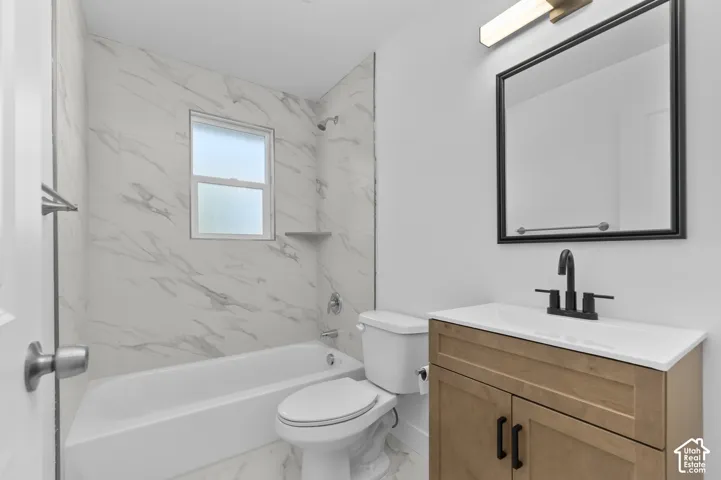 Wood-finish vanity with an integrated sink and matte black faucet