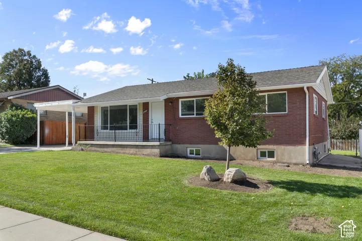 Brick exterior with a covered carport