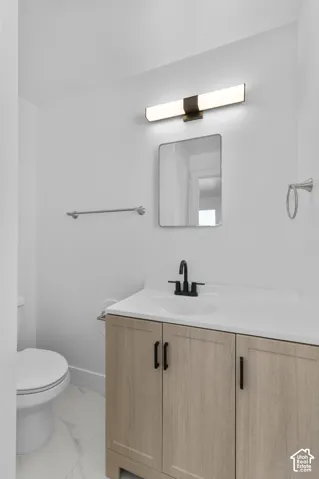 Wood-finish vanity with a white countertop and an undermount sink