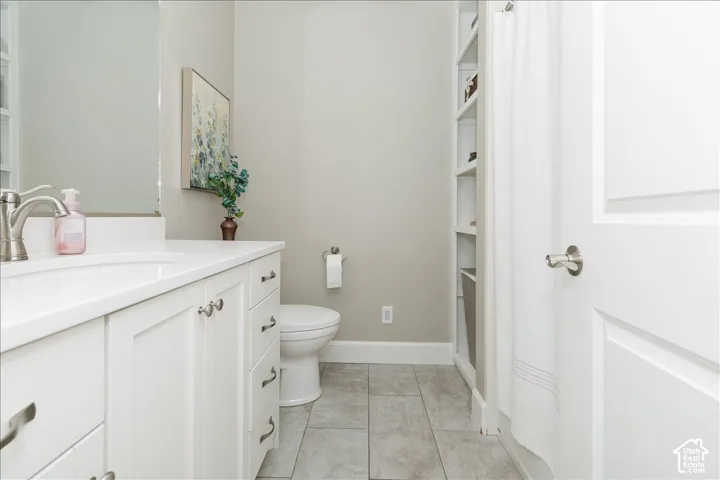 White vanity with brushed nickel hardware, integrated sink, and a single-handle faucet