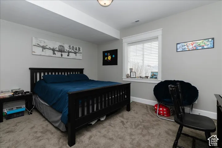 Carpeted flooring, window with blinds, and recessed lighting