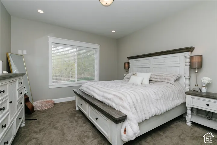 Recessed ceiling lighting, gray wall finish, carpeted flooring, and a window with white trim