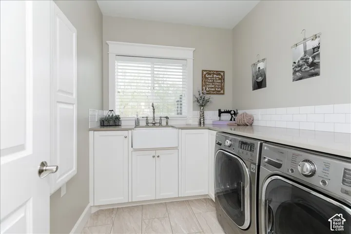 White shaker cabinetry, farmhouse sink with gooseneck faucet, light-toned countertops, white subway tile backsplash, and light wood-finish flooring