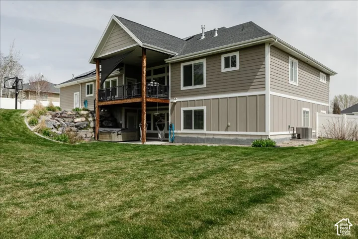 Expansive green lawn with a rock retaining wall and integrated landscaping