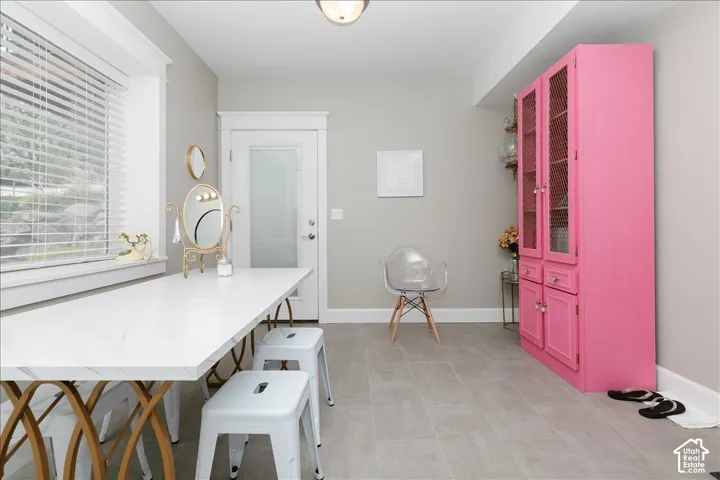 White trim molding with a modern door, finished flooring, built-in cabinetry, and a large window