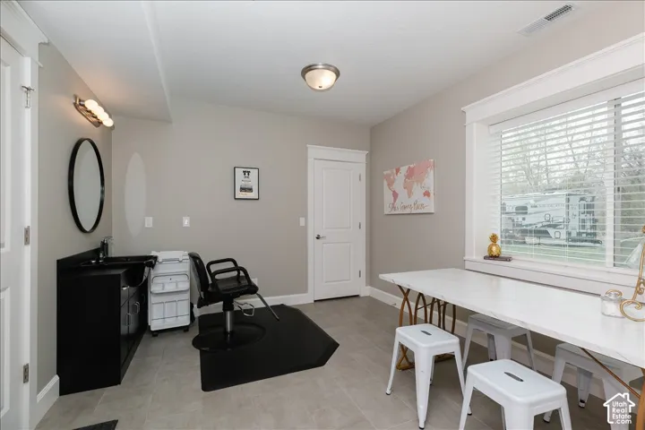 Recessed lighting, large window with blinds, light gray wall color, white trim, and light-toned flooring