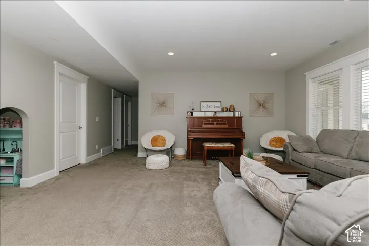 Recessed lighting, light-toned carpeting, and white trim throughout