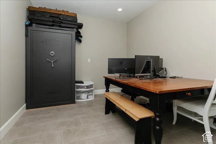 Recessed ceiling lighting, light gray wall paint, and gray tile flooring