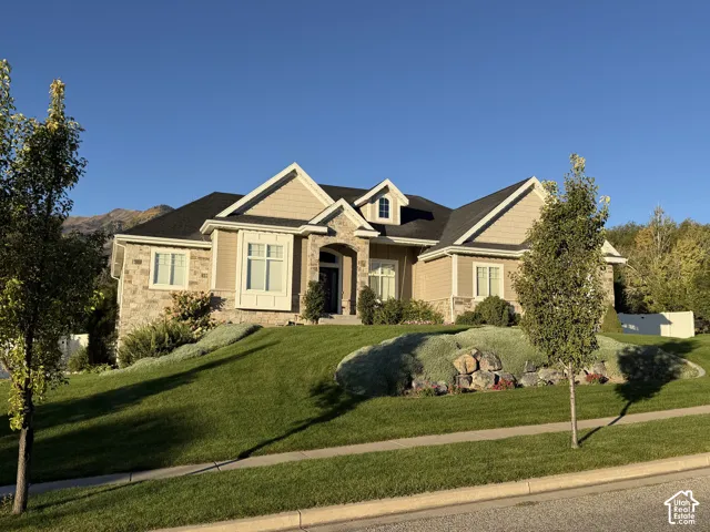 Stone and siding exterior with dark shingle roof