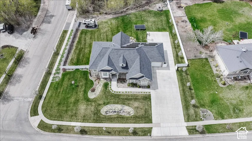 Generous corner lot with established landscaping and a concrete driveway