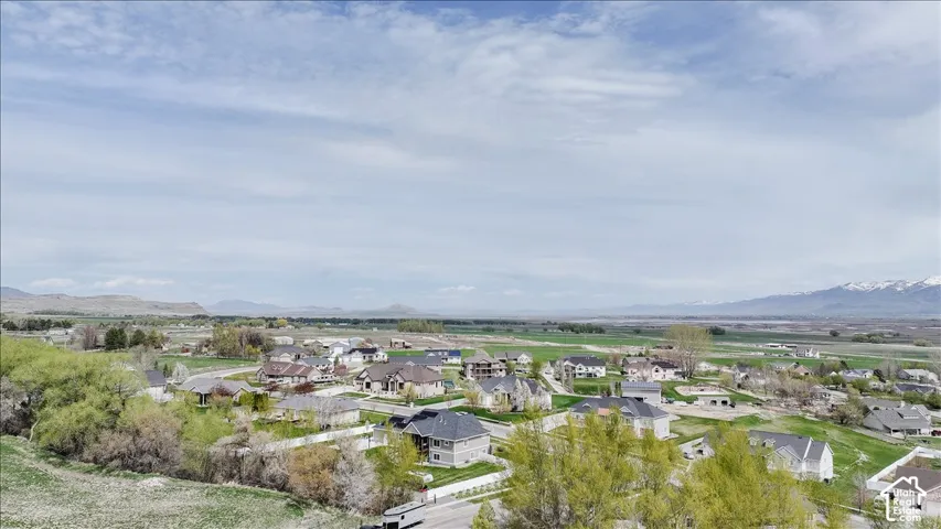 Expansive residential community with established homes, green spaces, and distant mountain ranges