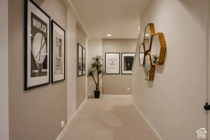 Carpeted flooring throughout, neutral wall tones, and recessed ceiling lighting