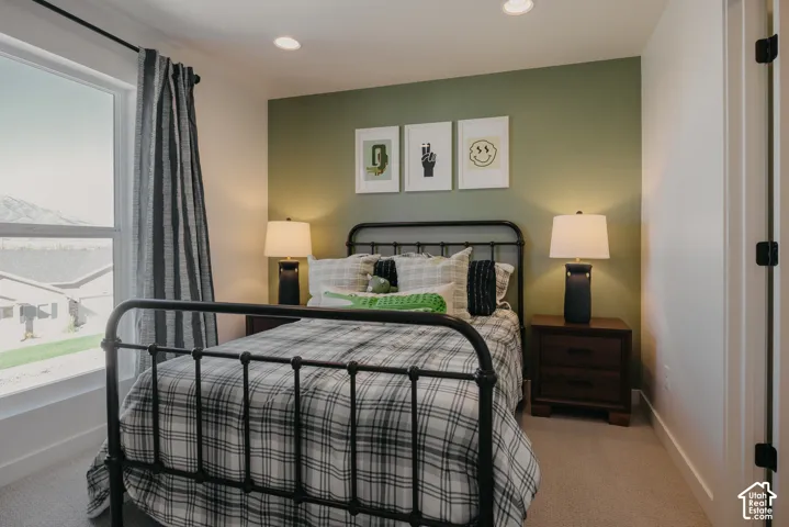 Window with exterior scenery, recessed lighting, wall-to-wall carpeting, and a contrasting accent wall