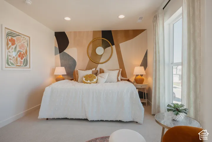 Recessed lighting, wall-to-wall carpeting, and a large window with drapes