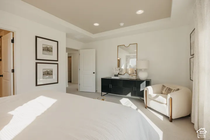 Recessed lighting, tray ceiling, carpeted flooring, and white interior doors