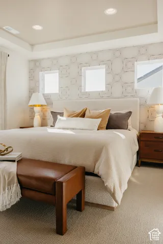 Recessed ceiling lighting, tray ceiling, textured wall covering, and neutral-toned carpeting