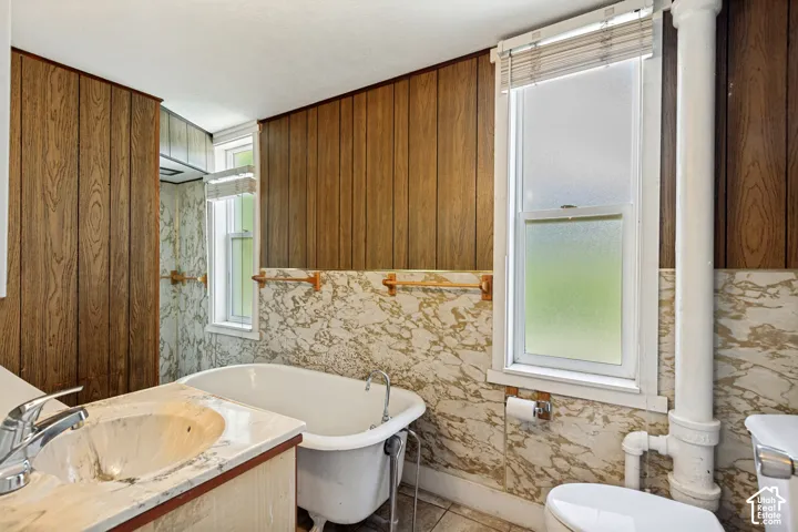 Wood-panel accent wall and marble-style wainscoting