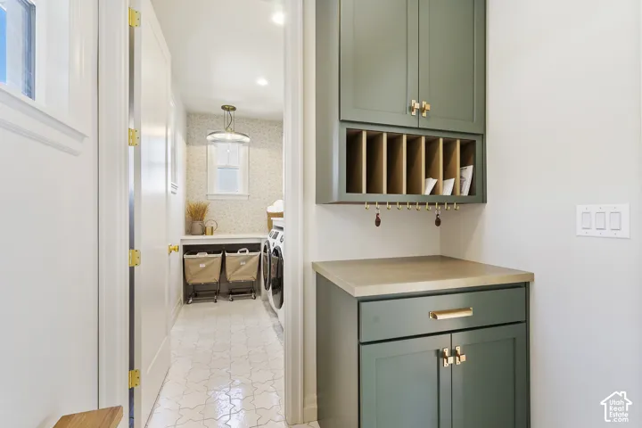 Built-in cabinetry with gold-finish hardware, functional shelving, and a durable countertop