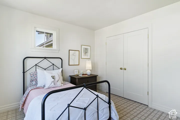 White interior walls with a single window, white trim, and a patterned carpet