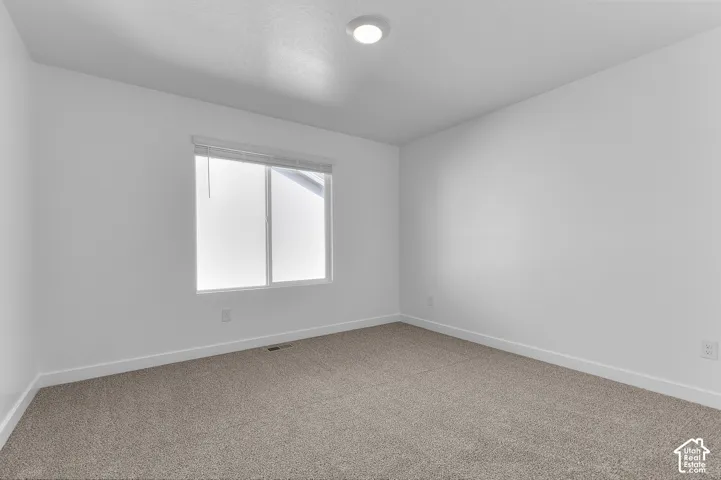 Neutral wall finishes, recessed lighting, and carpeted flooring