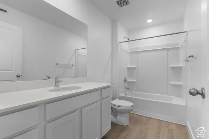 White vanity with a light-toned countertop and an integrated sink