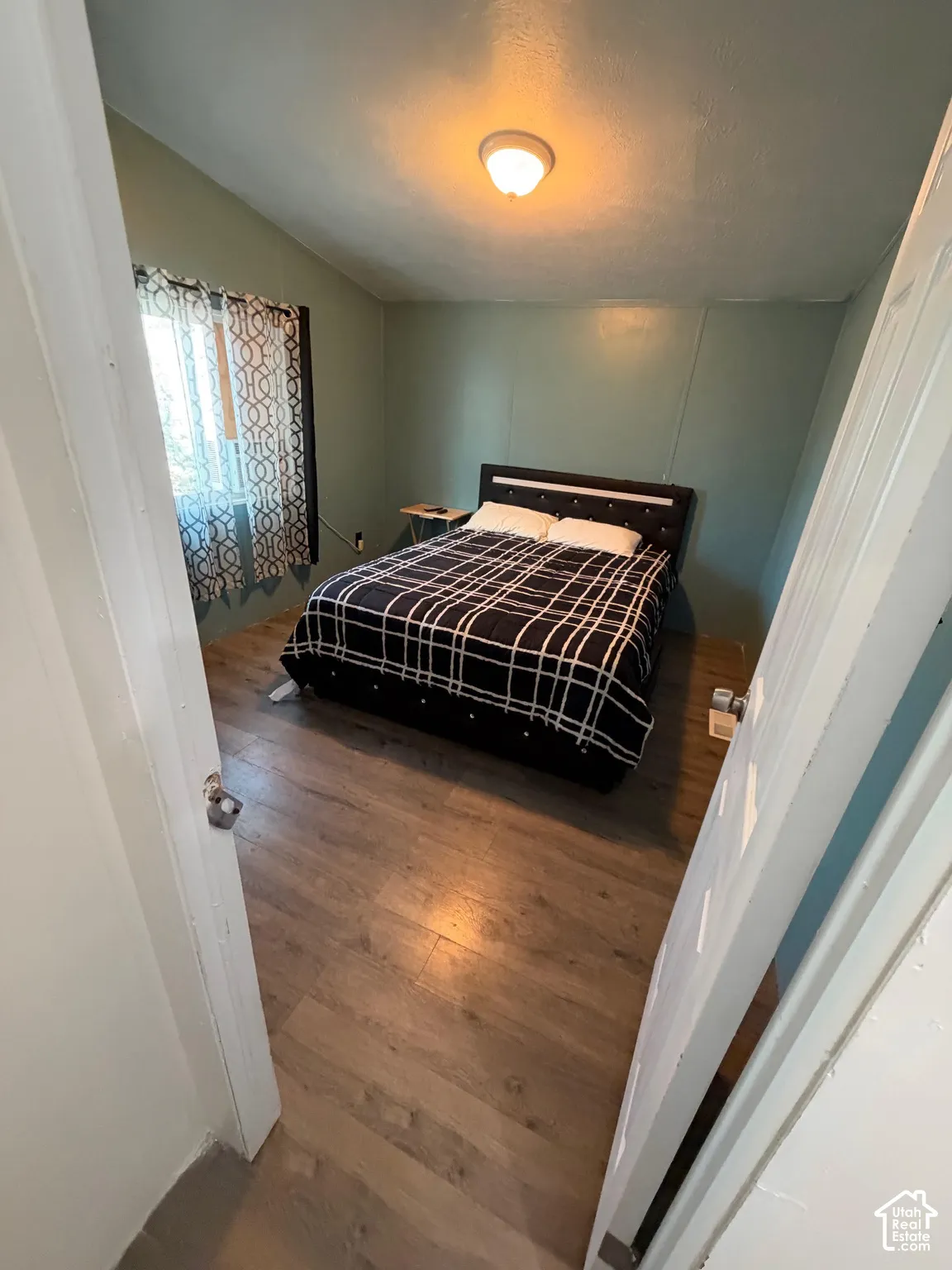 Recessed lighting, wood-finish flooring, and paneled walls