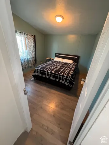 Recessed lighting, wood-finish flooring, and paneled walls