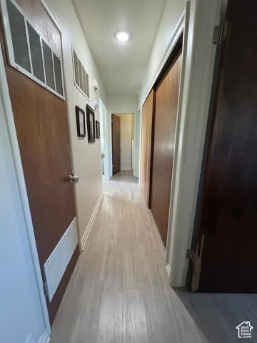 Wood-finish flooring throughout, recessed lighting, and solid core doors