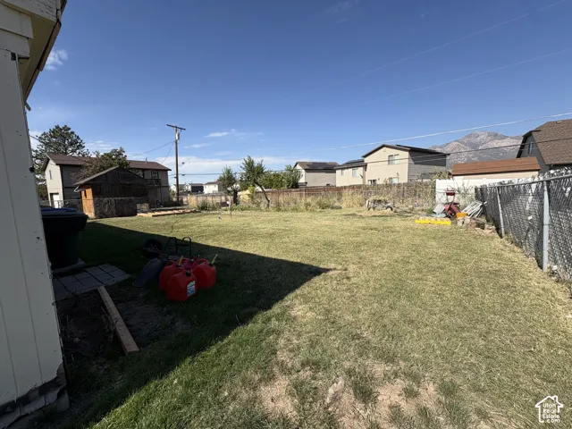 Expansive grassy yard with mountain scenery