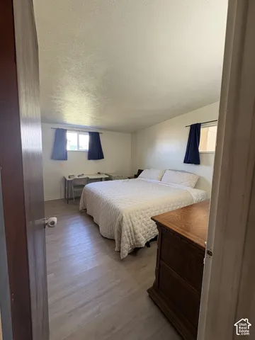 Room with wood-finish flooring and multiple windows