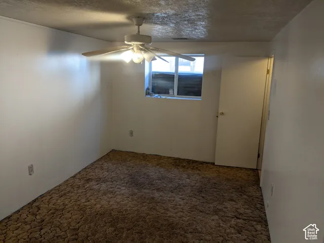Recessed window, ceiling fan with integrated lighting, and carpeted flooring