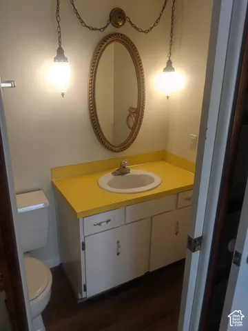 Vanity with a yellow countertop, integrated sink, and white cabinetry