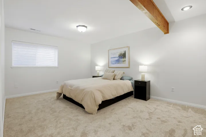 Recessed lighting, wood-finish ceiling beam, wall-to-wall carpeting, window with horizontal blinds, and white painted walls