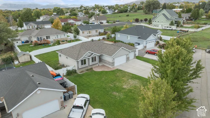 Single-story residence featuring a gray exterior, stone facade accents, and a dual garage