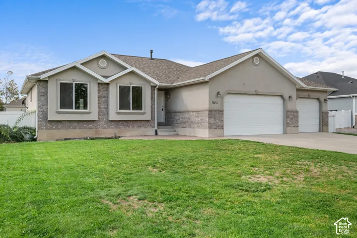 Stucco exterior with stone accenting, prominent gables, and a multi-car garage