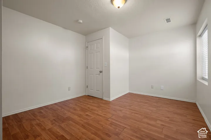 Warm wood-finish flooring complements light-toned walls