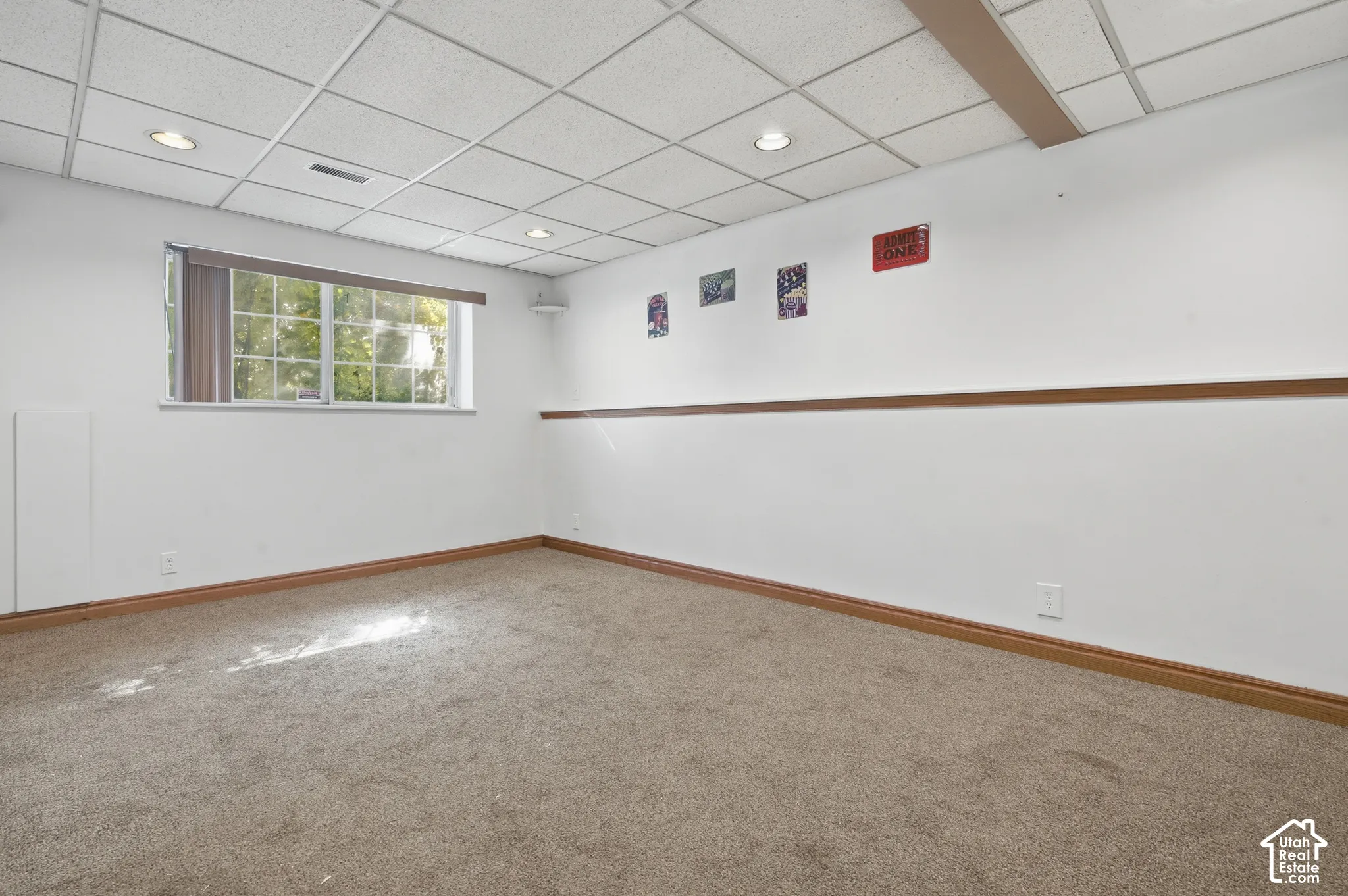 Recessed lighting, drop ceiling, wood-finish trim, and a horizontal window