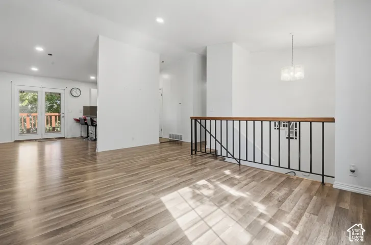 Wood-finish flooring throughout, with a wood and wrought iron railing