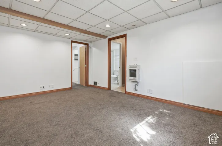 Recessed lighting, wood-finish trim, neutral wall tones, and carpet flooring